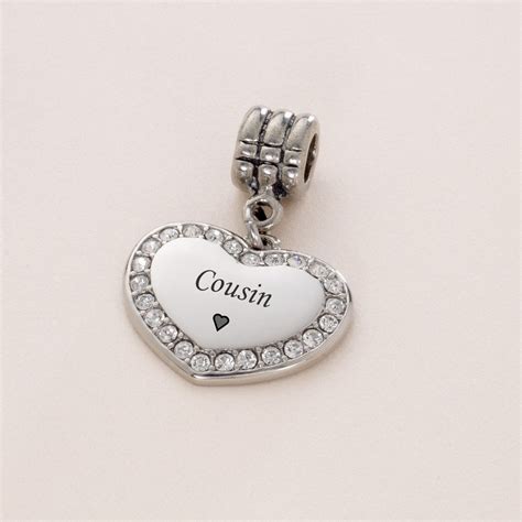 The cute girl holds a teddy bear in her arms, who in turn holds a pink enamel heart. . Cousin pandora charm